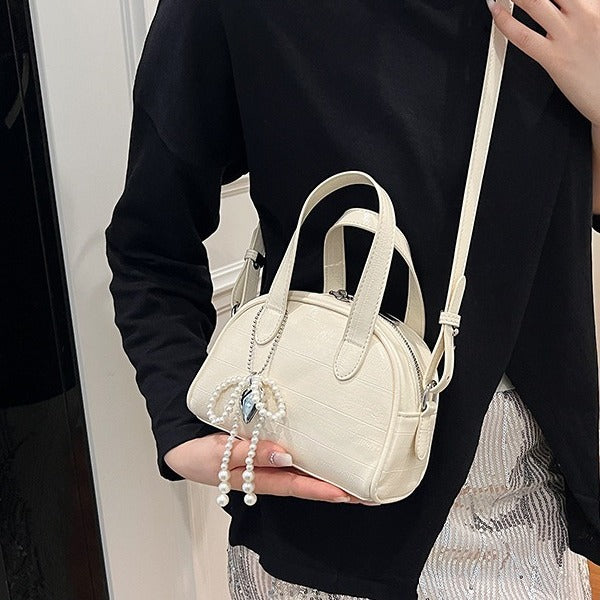 mini handbag with stylish crocodile look and detachable pendant