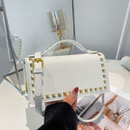mini handbag with glittering upper material and golden studs