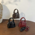mini handbag with shiny surface and trendy zipper