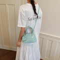Ladies mini handbag with playful polka dot pattern and removable shoulder strap