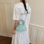 Ladies mini handbag with playful polka dot pattern and removable shoulder strap