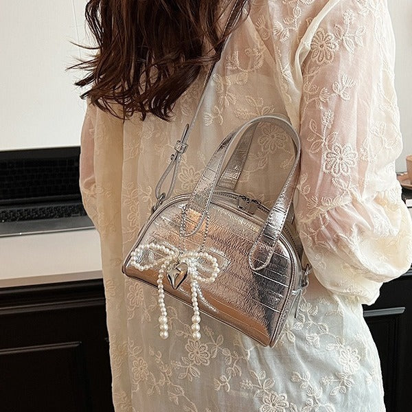mini handbag with stylish crocodile look and detachable pendant