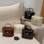 mini handbag in elegantly curved design with playful charm