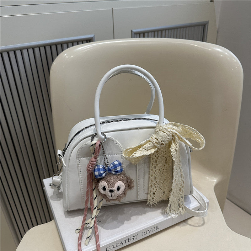 mini handbag with playful animal design and charming pendant