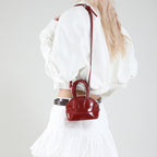 mini handbag with elegant glossy finish and removable shoulder strap