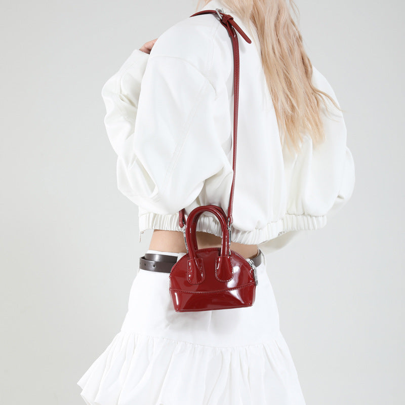 mini handbag with elegant glossy finish and removable shoulder strap