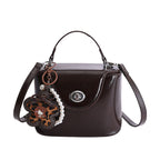 mini handbag in elegantly curved design with playful charm