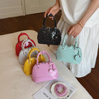 Ladies mini handbag with playful polka dot pattern and removable shoulder strap