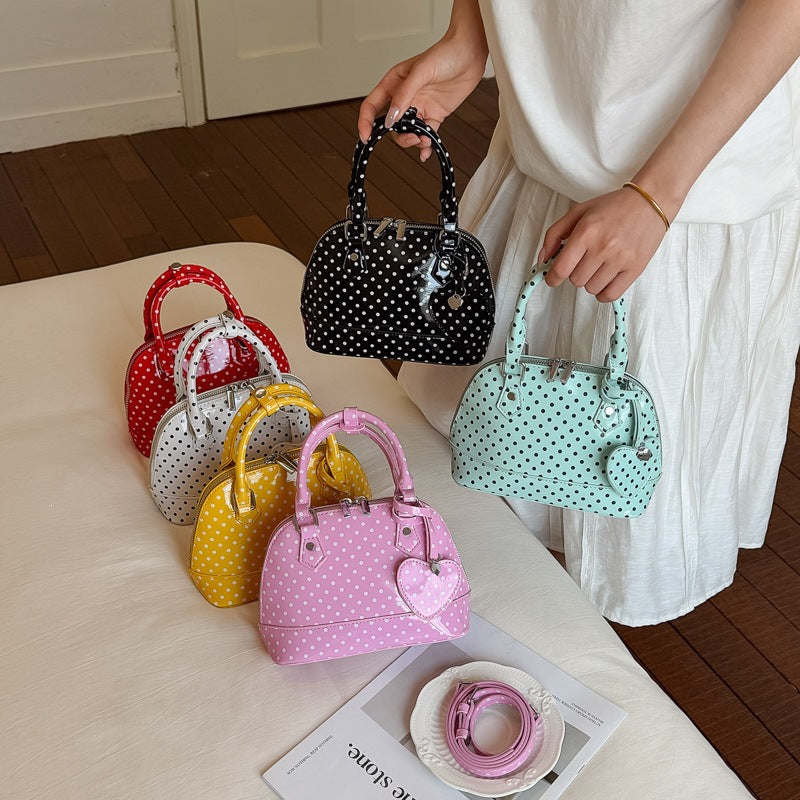 Ladies mini handbag with playful polka dot pattern and removable shoulder strap