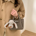 Ladies mini handbag with playful design and animal pendant
