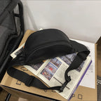 Belt bag with adjustable carrying strap and practical compartments