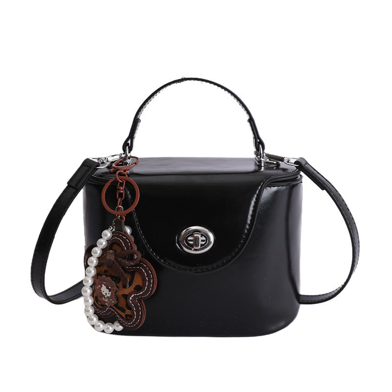mini handbag in elegantly curved design with playful charm
