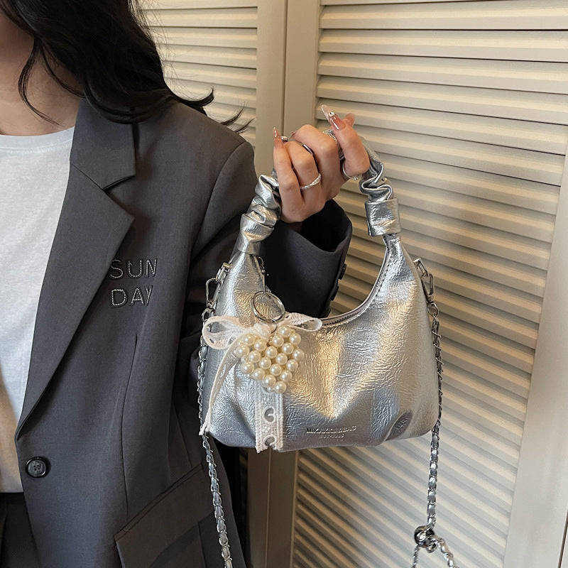 mini handbag with voluminous ruffle design and trendy pendants