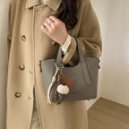Ladies mini handbag in elegant design with charming pendant