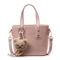 mini handbag with textured design and fluffy pendant