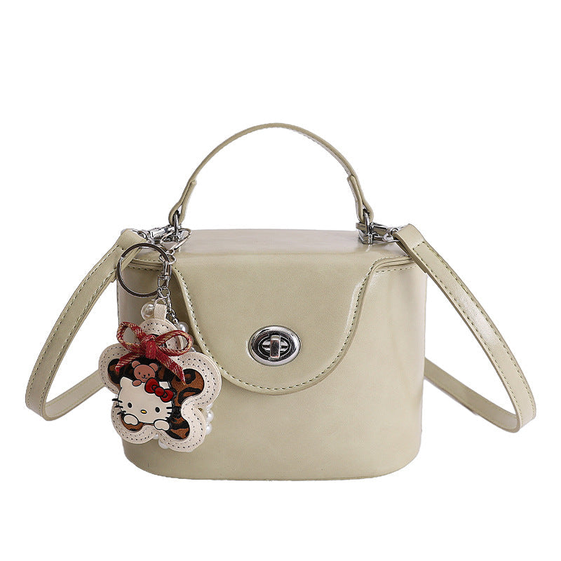 mini handbag in elegantly curved design with playful charm