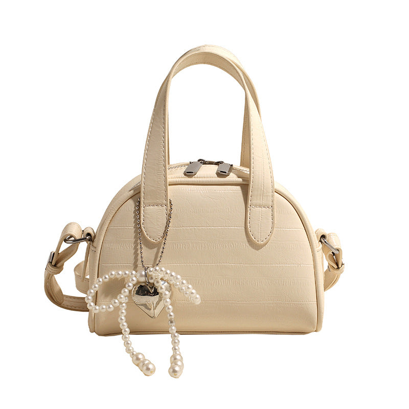 mini handbag with stylish crocodile look and detachable pendant