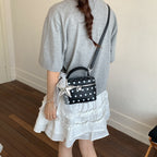 Women’s mini handbag with playful design and elegant accents