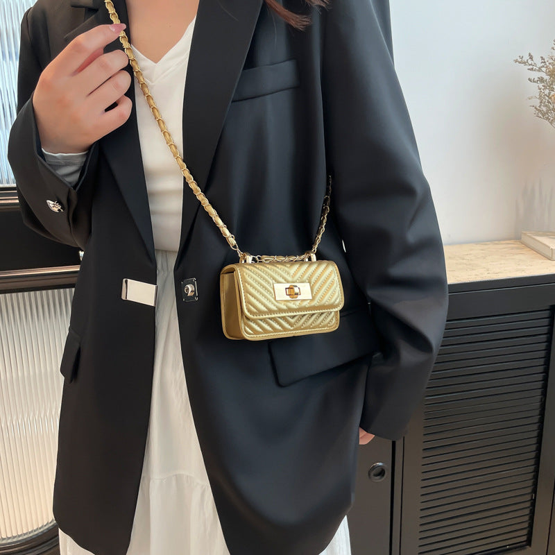 mini handbag with quilted design and golden closure