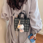 mini handbag with checkered design and playful pendant