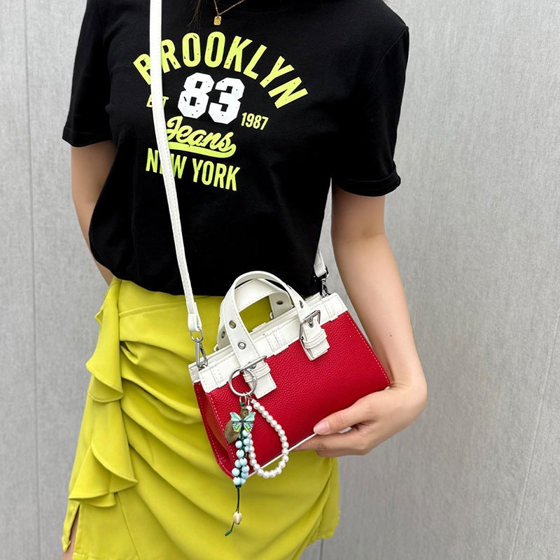 mini handbag with playful pendant and elegant design