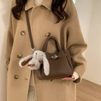 Ladies mini handbag with playful design and animal pendant