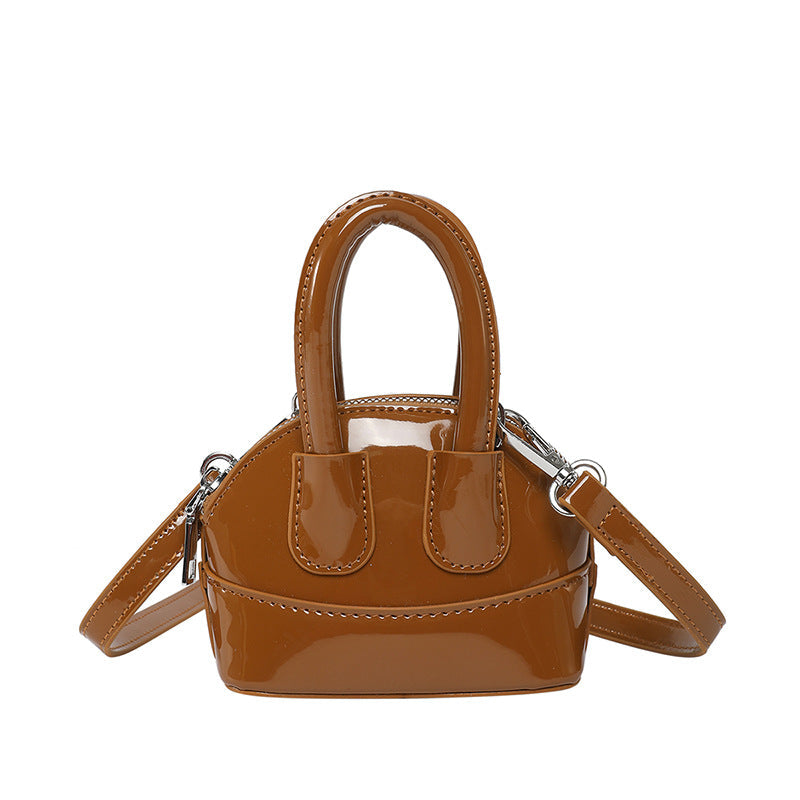 mini handbag with elegant glossy finish and removable shoulder strap