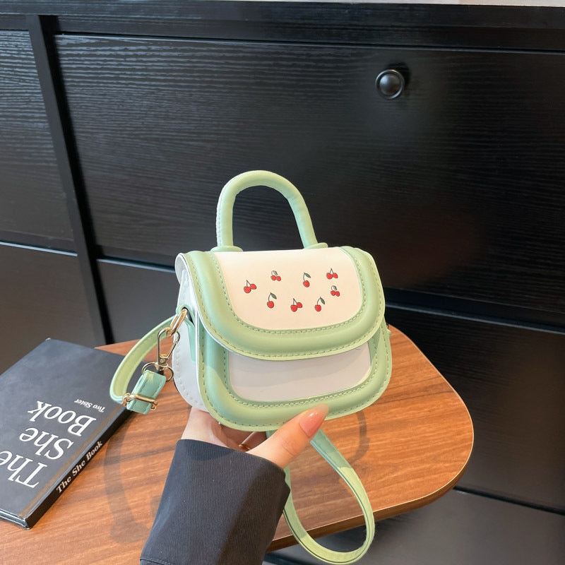mini handbag with cheerful cherry design and charming charms