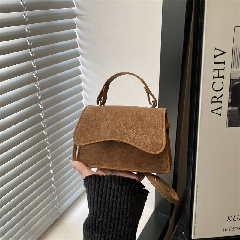 Ladies mini handbag with detachable carrying handle