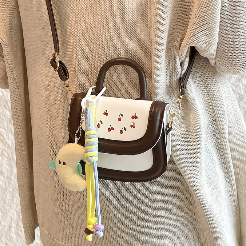 mini handbag with cheerful cherry design and charming charms