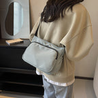 Practical shoulder bag with versatile storage compartments