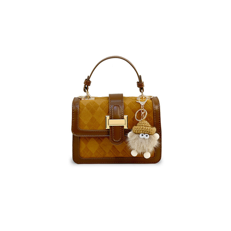 Women’s mini handbag with decorative braided pattern and playful charm