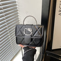 mini handbag with decorative quilting and playful cat motif