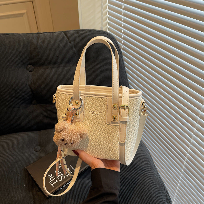 mini handbag with textured design and fluffy pendant