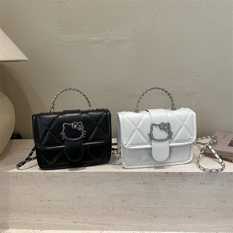 mini handbag with decorative quilting and playful cat motif