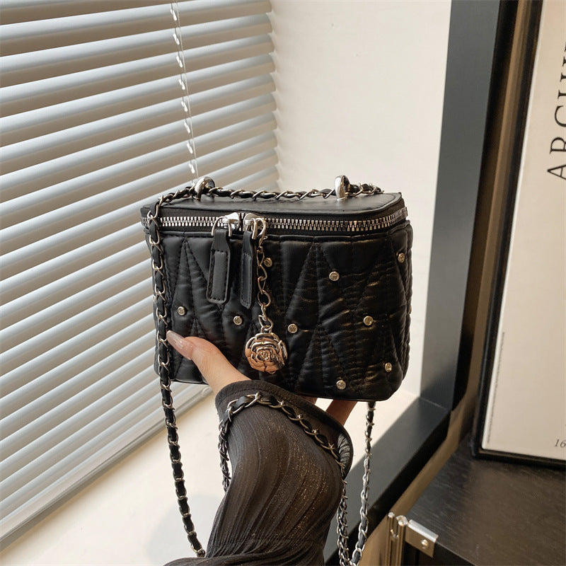 mini handbag with elegant quilting and chain pendant