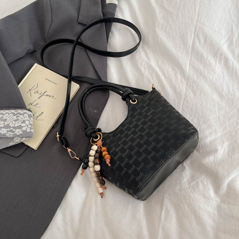 Ladies mini handbag with shimmering upper material and elegant accessories