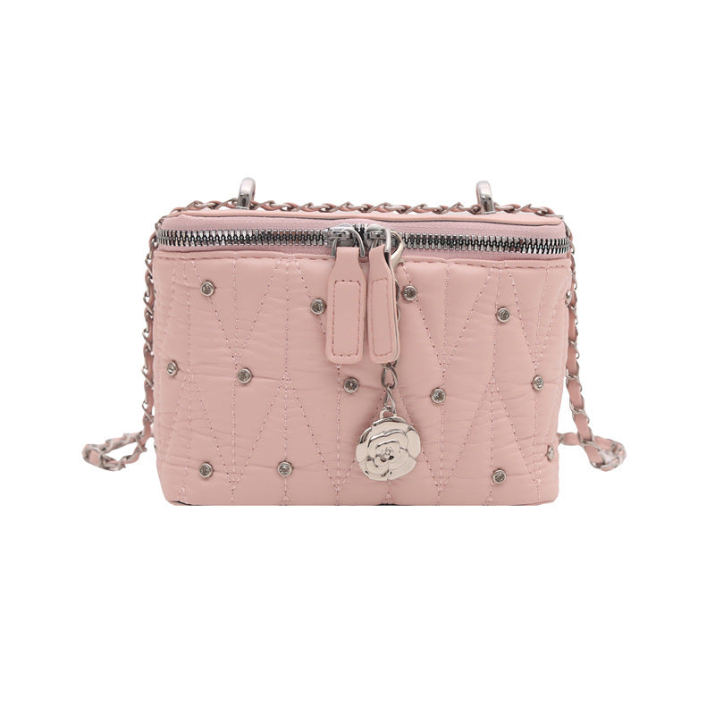 mini handbag with elegant quilting and chain pendant