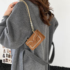 mini handbag with elegant quilted pattern and golden accents