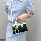 mini handbag with playful pendant and elegant design