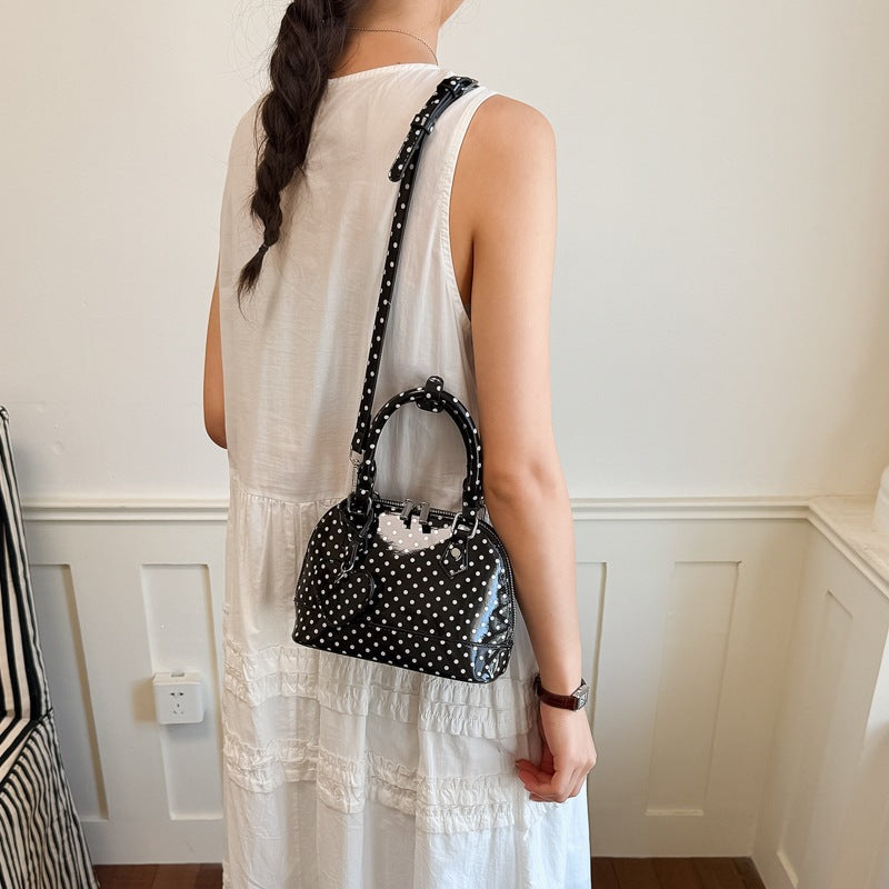 Ladies mini handbag with playful polka dot pattern and removable shoulder strap