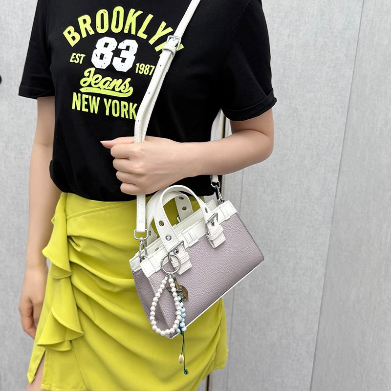 mini handbag with playful pendant and elegant design