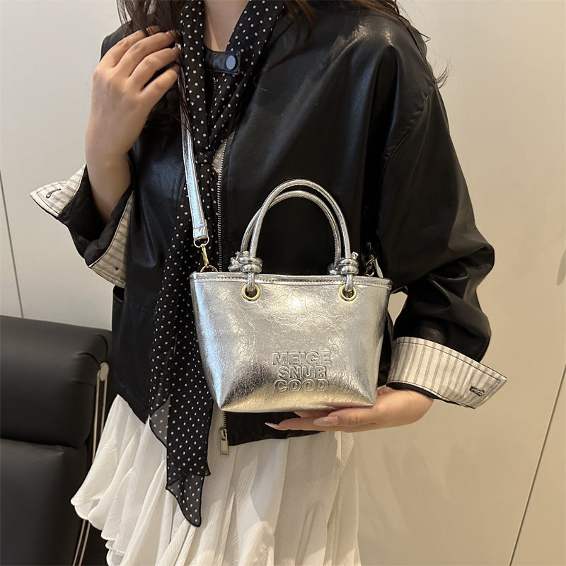 elegant mini handbag with textured design and detachable shoulder strap
