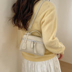 mini handbag with fine decorative seams and removable shoulder strap