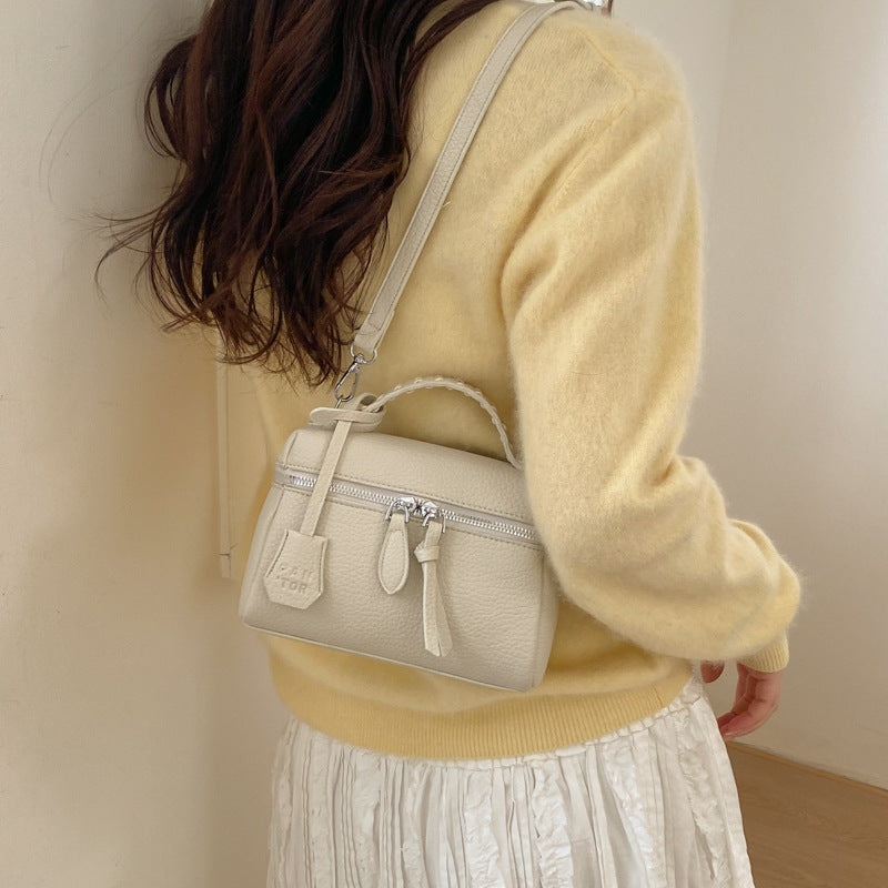 mini handbag with fine decorative seams and removable shoulder strap