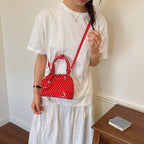 Ladies mini handbag with playful polka dot pattern and removable shoulder strap