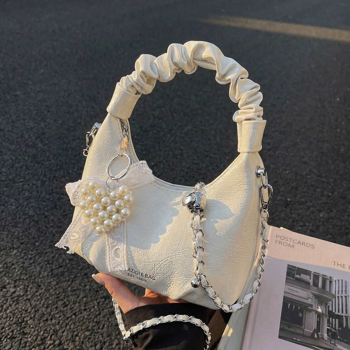 mini handbag with voluminous ruffle design and trendy pendants