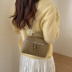 mini handbag with fine decorative seams and removable shoulder strap