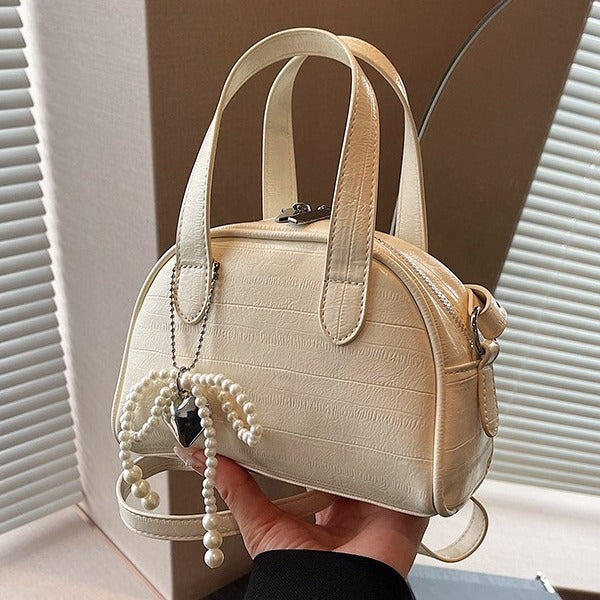 mini handbag with stylish crocodile look and detachable pendant