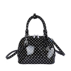 Ladies mini handbag with playful polka dot pattern and removable shoulder strap